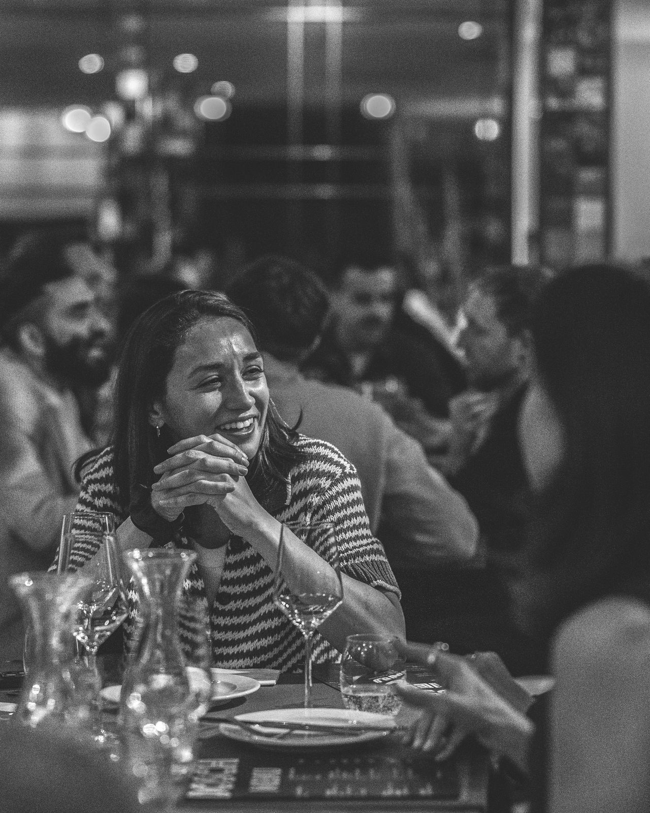 A guest laughing, black and white